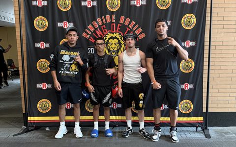 Four East Reading Boxing Club fighters and their coach standing in front of the Ringside King of the Jungle National Championships banner at DeVos Place in Grand Rapids.